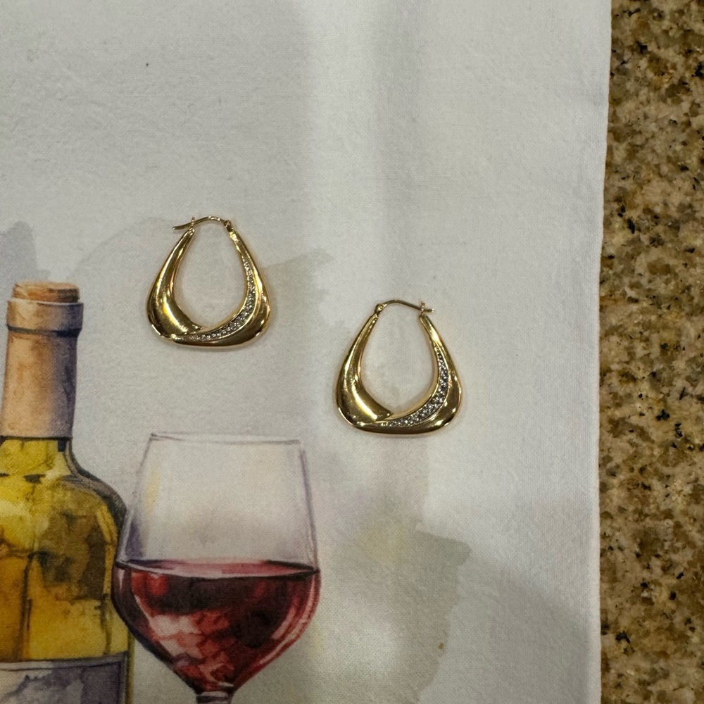 14 karat Gold hoop earrings with diamond accents.